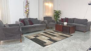 a living room with couches and a table and a rug at Beautiful semi villa with private entrance in Sheikh Zayed- villa queen in Sheikh Zayed +53 photos