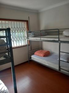 a room with two bunk beds and a window at PRIME ALOJAMNETOS 01 in Gondomar