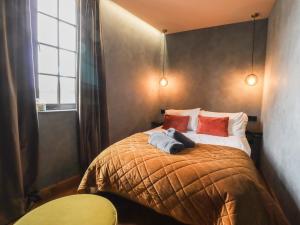 a bedroom with a bed with two towels on it at The Old Fish Bar in Margate