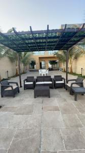 a group of benches sitting under a pavilion at درة العروس فيلا فاخره بمسبح داخلي in Durat  Alarous