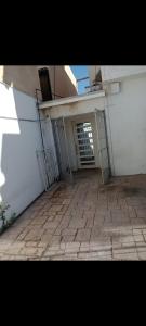 an open door to a building with a brick patio at Media luna in Ciudad Juárez