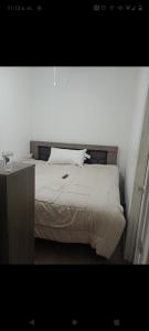 a bed with white sheets and pillows in a bedroom at Media luna in Ciudad Juárez