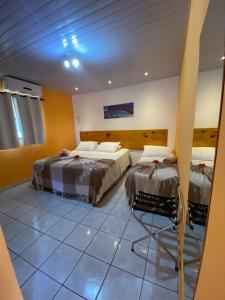 Un pat sau paturi într-o cameră la Pousada Guedes Noronha