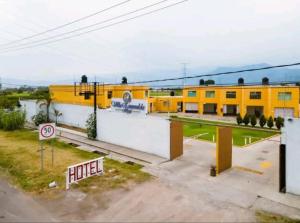 a yellow building with a street sign in front of it at Hotel Villa Esmeralda in Cuautla Morelos