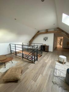 a room with a loft with a bed and a table at La Ferme du Maillot in Champeau