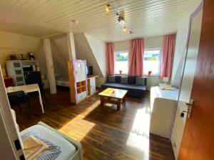 a living room with a couch and a table at Ferienzimmer Fischach in Fischach