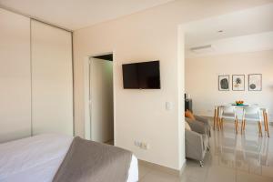a bedroom with a bed and a couch and a table at Báltico Suites in Buenos Aires
