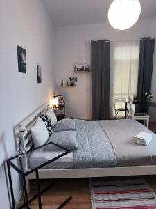 a bedroom with a bed and a glass table at Cozy Apartments and Rooms Katowice in Katowice