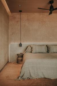 a bedroom with a bed and a ceiling fan at MIRA Earth Studios in San Antonio de las Minas