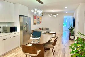 una cocina con mesa y ordenador portátil. en Bright, airy, luxe hideaway”w” private backyard, en Brooklyn