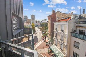 a view of a city street from a balcony at La terrasse d'Issy - Welkeys in Issy-les-Moulineaux