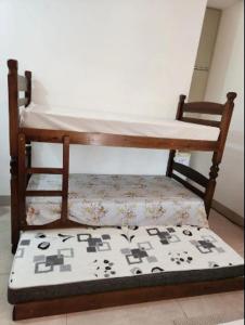 een houten stoel met een kussen op een tafel bij Suíte Garagem 8min do Acqualinda 1 a 5 pessoas in Andradina