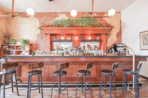a bar with black stools in front of it at Imperial Hotel + Restaurant in Amador City