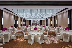 北京北京新青海喜来登酒店的宴会厅里摆放着白色的桌椅和一盏枝形吊灯 更多37张照片