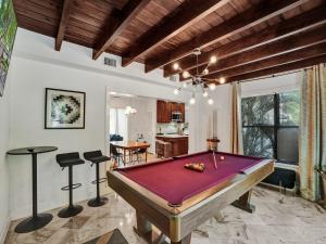 a ping pong table in a living room with a pool table at 10 Mins to South Beach Miami 4 Bedroom Villa in Miami