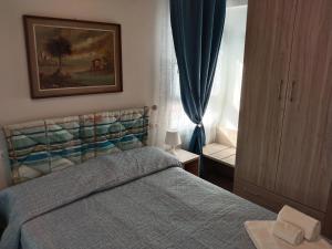 a bedroom with a bed and a window at ANGI B&B in Budrio