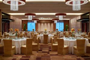 a banquet hall with white tables and chairs and chandeliers at Four Points By Sheraton Beijing, Haidian in Beijing
