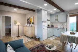 a living room with a blue couch and a kitchen at Casa Regente in O Viso