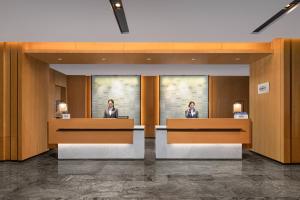 two women sitting at desks in a lobby at Fairfield by Marriott Xining North in Xining