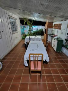 patio con mesa y sillas y cocina en Aconchego Lar Cama e Café, en Foz do Iguaçu