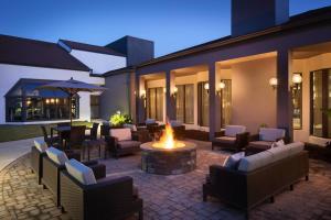 a patio with a fire pit with chairs and tables at Courtyard by Marriott Birmingham Homewood in Birmingham
