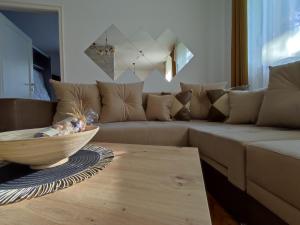 a living room with a couch and a wooden table at High T in Kraljevo