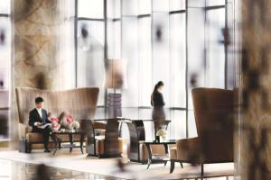 a man and a woman standing in a lobby at The Ritz-Carlton, Chengdu in Chengdu