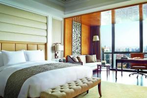 a bedroom with a large bed and a large window at The Ritz-Carlton, Chengdu in Chengdu