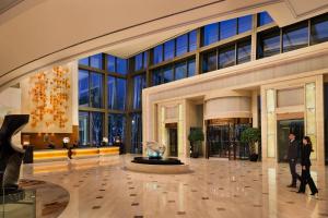 a lobby with people walking in a building at JW Marriott Hotel Shanghai Changfeng Park in Shanghai