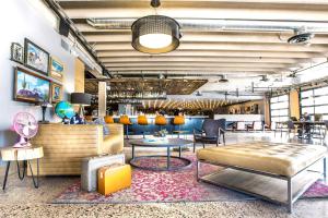 a lobby with a couch and tables and chairs at MOXY Phoenix Tempe/ASU Area in Tempe