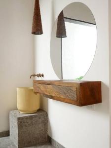 a bathroom with a mirror and a sink at Casa Amarilla in Honda