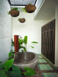 a bathroom with a large tub with plants in it at Casa Amarilla in Honda +4 photos