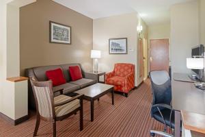 a hotel room with a couch and a chair at Best Western Plus Bradbury Inn and Suites in Waycross