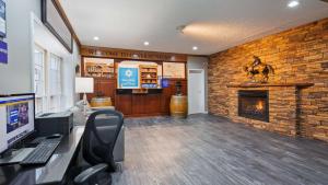 an office with a brick wall with a fireplace at SureStay Hotel by Best Western Bardstown General Nelson in Bardstown