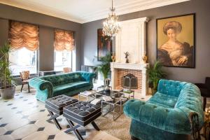 a living room with blue couches and a fireplace at Hotel Vendome - BW Signature Collection in Vendôme