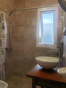 a bathroom with a sink and a toilet and a window at Matilde`s Sun in Godoy Cruz +15 photos