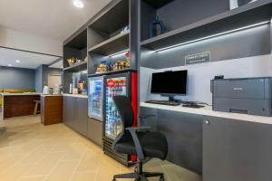 a office with a refrigerator and a desk with a computer at Comfort Inn & Suites Houma in Houma +77 photos