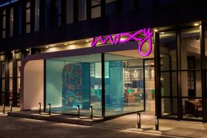 a store front with a neon sign on it at Moxy Shanghai Hongqiao NECC in Shanghai