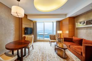 a living room with a couch and a table at The Westin Nanjing Xuanwu Lake in Nanjing