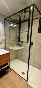 a glass shower in a bathroom with a sink at Entre mare et chêne in Frasnes-lez-Anvaing