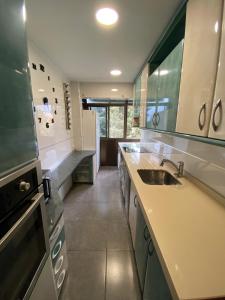a large kitchen with a sink and a stove at APARTAMENTO GOR in Granada