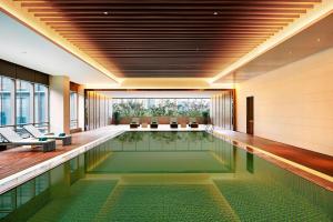 a pool in the middle of a hotel lobby at Element Suzhou Science and Technology Town in Suzhou