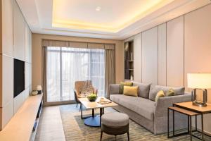 a living room with a couch and a table at Marriott Executive Apartments Hangzhou Yuhang in Hangzhou