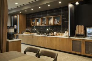 a restaurant with a counter and chairs in a room at SpringHill Suites by Marriott Las Vegas Airport in Las Vegas