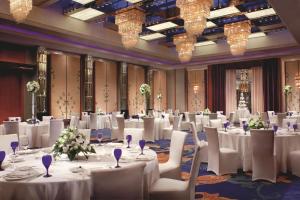 a banquet hall with white tables and chairs and chandeliers at The Ritz-Carlton, Shenzhen in Shenzhen