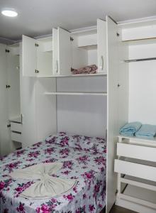 Schlafzimmer mit einem Bett und weißen Schränken in der Unterkunft Apt 1 qto wifi - netflix - ar condicionado - prox ao metrô -ambiente familiar. in Ceilândia