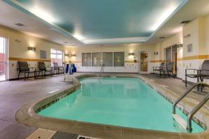 a pool with blue water in a hotel room at Fairfield Inn and Suites Hutchinson in Hutchinson