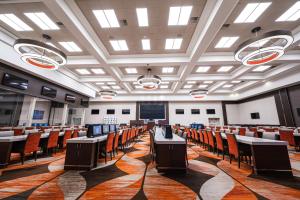 a conference room with tables and chairs and a screen at Boulder Station Hotel & Casino in Las Vegas