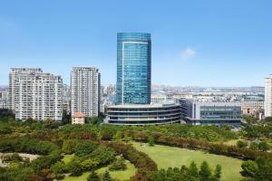 a city skyline with tall buildings and a park at Courtyard by Marriott Shanghai Songjiang in Songjiang