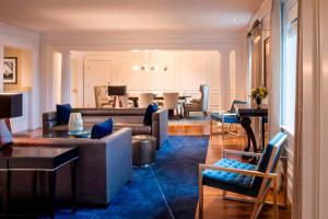 a living room with couches and a dining room at Renaissance Providence Downtown Hotel in Providence